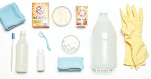 Cleaning tools for washing machine: microfiber cloth, toothbrush, gloves, vinegar, baking soda, bleach.
